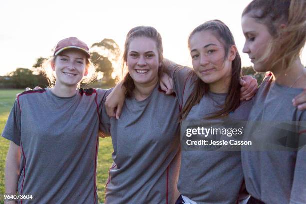 group portrait of team players on the sports field in the evening light - new zealand cricket stock pictures, royalty-free photos & images