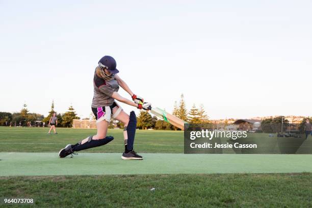 female cricketer batting in evening light - new zealand cricket stock pictures, royalty-free photos & images