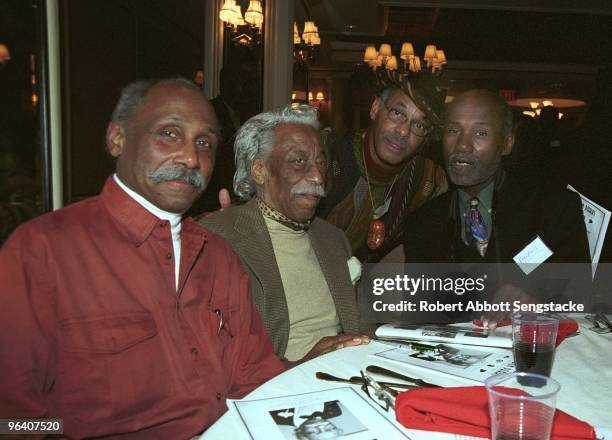 American photographer and filmmaker Gordon Parks sits with others at his 90th birthday party, New York, New York, November 30, 2002.