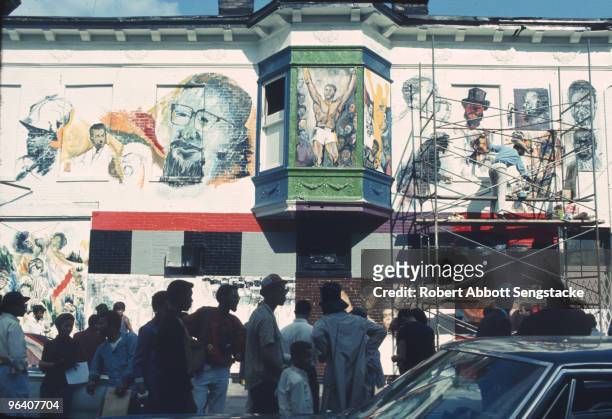Neighborhood residents and artists gather during the creation of 'The Wall of Respect', a public art project conceived by OBAC , Chicago, Illinois,...