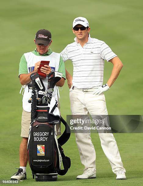 Gregory Bourdy of France plays his second shot to the par 4, 12th hole during the first round of the 2010 Omega Dubai Desert Classic on the Majilis...