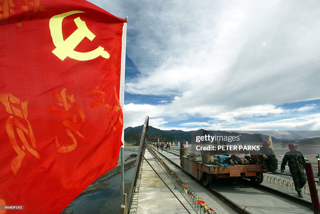 A communist flag flies over the railway
