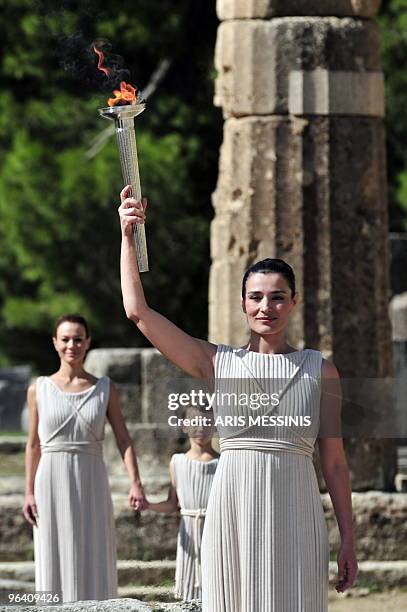 Actress Maria Nafpliotou, in the role of an ancient Greek high priestess, holds the Olympic Flame during the official lighting ceremony for the...