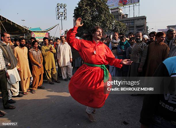 Pakistani Sufi Muslim dances outside the Data Darbar, which has the shrine of Saint Syed Ali bin Osman Al-Hajvery, popularly known as Data Ganj...