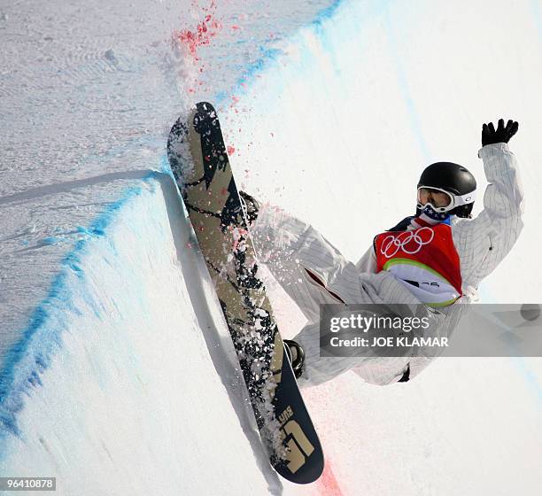 Halfpipe snowboarder Shaun White hits the edge during the Men's snowboard Halfpipe first qualifying run on the second day of the Turin 2006 Winter...