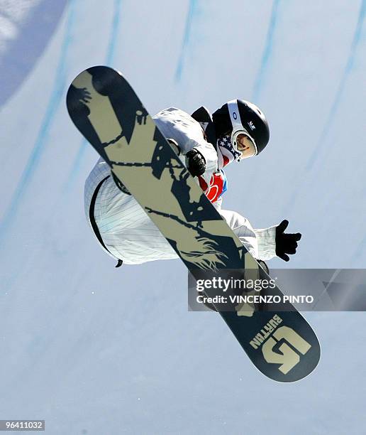 Halfpipe snowboarder Shaun White competes during the first run of the Men's snowboard Halfpipe final on the second day of the Turin 2006 Winter...