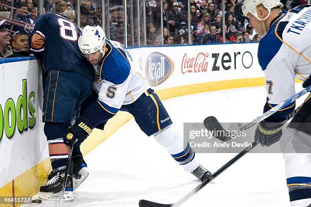 Barret Jackman of the St. Louis Blues pins Sam Gagner of the Edmonton Oilers against the boards at Rexall Place on January 28, 2010 in Edmonton,...