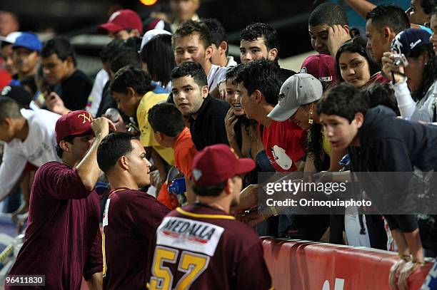 Fans of Puerto Rico's Indios de Mayaguez, interact with players before the game against Venezuela's Leones del Caracas as part of the Caribbean...