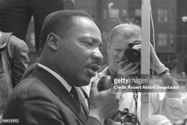 In a West Side neighborhood, American clergyman and civil rights leader Dr. Martin Luther King Jr. Addresses hundreds of supporters and members of...