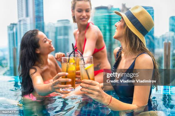 party on rooftop swimming pool - rooftop pool stock pictures, royalty-free photos & images