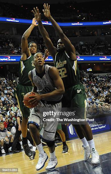 February 3: Georgetown's Greg Monroe, center, is double teamed by South Florida's Jared Famous, left, and Toarlyn Fitzpatrick, right, during the game...