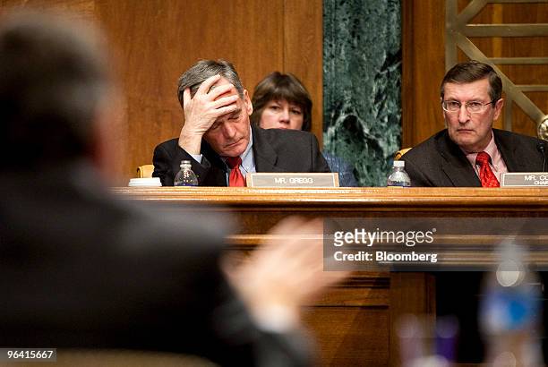 Senator Kent Conrad, chairman of the Senate Budget Committee, right, and Senator Judd Gregg, a Republican from New Hampshire, react to testimony from...