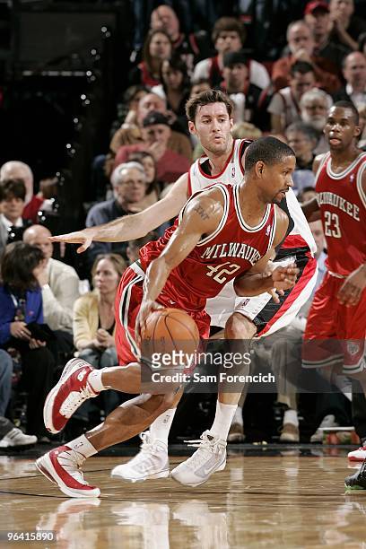 Charlie Bell of the Milwaukee Bucks drives the ball around Rudy Fernandez of the Portland Trail Blazers during the game on January 13, 2010 at the...