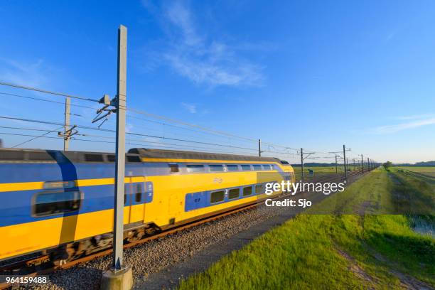 intercity train of the dutch railways driving in springtime landscape - kampen overijssel stock pictures, royalty-free photos & images