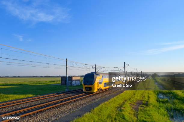 intercity train of the dutch railways driving in springtime landscape - kampen overijssel stock pictures, royalty-free photos & images