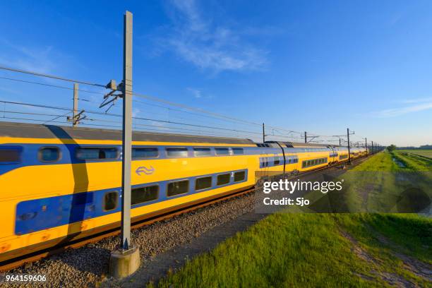 intercity train of the dutch railways driving in springtime landscape - kampen overijssel stock pictures, royalty-free photos & images