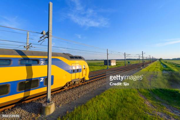 intercity train of the dutch railways driving in springtime landscape - kampen overijssel stock pictures, royalty-free photos & images