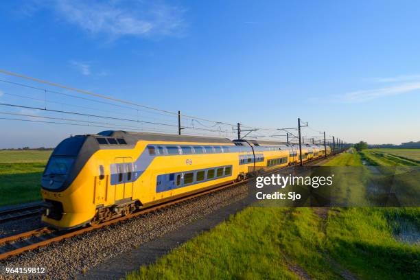 intercity train of the dutch railways driving in springtime landscape - kampen overijssel stock pictures, royalty-free photos & images