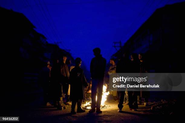 Kashmiri muslim protesters defying curfew gather around a fire before throwing stones towards Indian police during a protest on February 04, 2010 in...