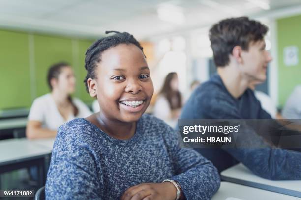 portrait of teenage student smiling in classroom - learning difficulty stock pictures, royalty-free photos & images