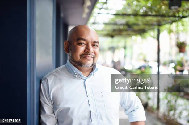 middle aged man standing outside his business - malasia 個照片及圖片檔