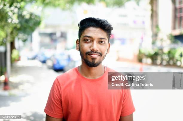 portrait of a young malaysian indian man on the street - インド系民族 ストックフォトと画像