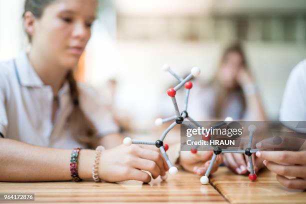 girls analyzing structure of molecule in lab - physics student stock pictures, royalty-free photos & images