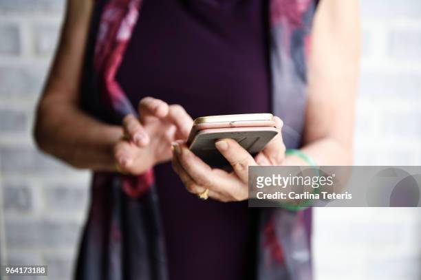 hands of a senior chinese lady using a smart phone - finger dialing touch tone telephone stock pictures, royalty-free photos & images