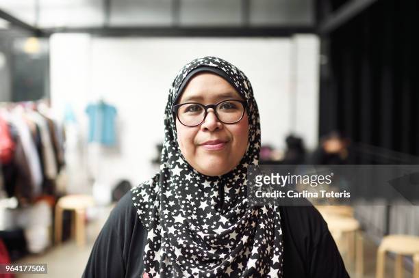 portrait of a malay woman in a clothing store - islam women stock pictures, royalty-free photos & images