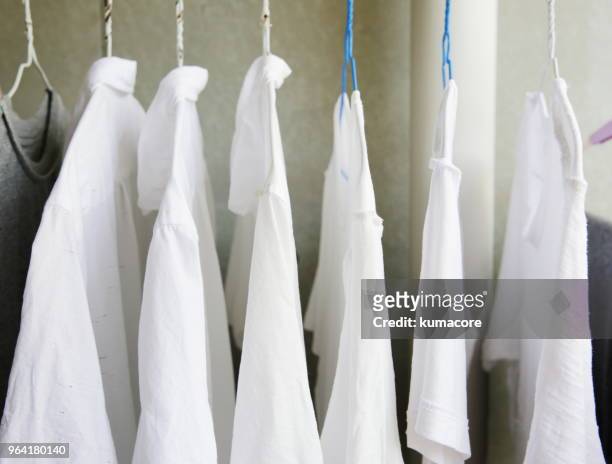 clothes hanging on hangers - shirt no people foto e immagini stock