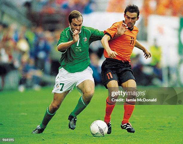 Marc Overmars of Holland is closed down by Jason McAteer of the Republic of Ireland during the World Cup Qualifier played at Lansdowne Road in...