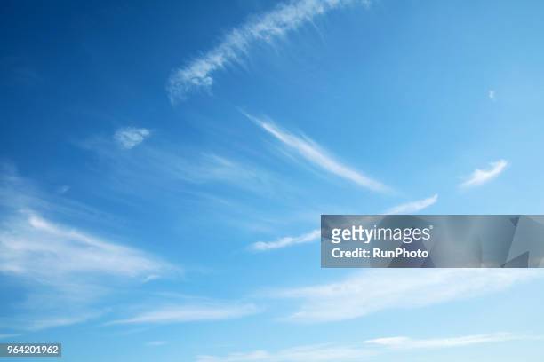 low angle view of clouds in blue sky - clear sky stock-fotos und bilder