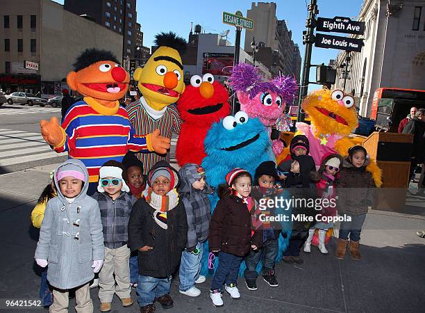 Sesame Street characters Ernie, Burt, Elmo, Cookie Monster, Abby Cadabby, and Zoe pose with children from the Garden of Dreams Foundation at the...