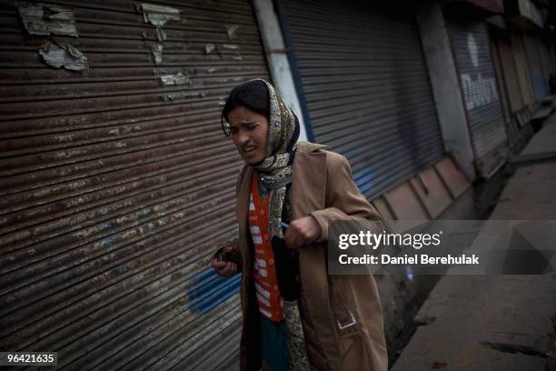 Kashmiri muslim woman grimaces with pain after being hit by a stray stone during a protest on February 04, 2010 in Srinagar, Kashmir, India. Soldiers...