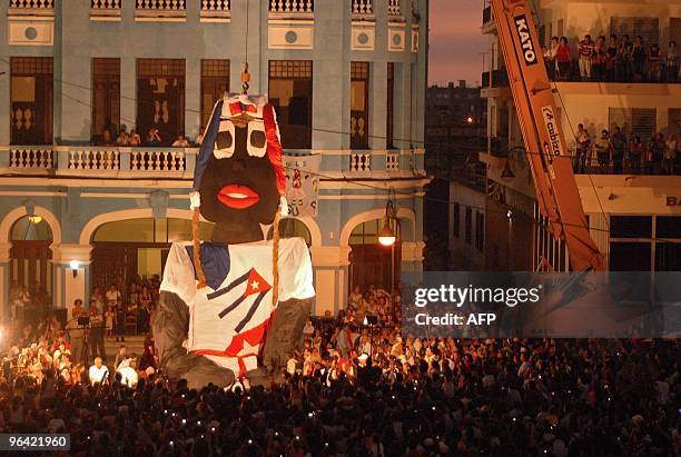 An 18-meter rag doll is held up by a crane in the central park of Camaguey, Cuba on February 3, 2010. The rag doll hopes to win the Guinness record....