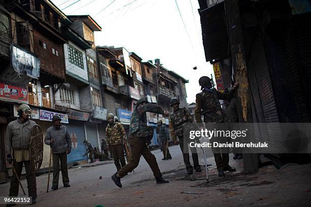 Indian police throw stones at Kashmiri protesters defying curfew during a protest on February 04, 2010 in Srinagar, Kashmir, India. Soldiers dressed...