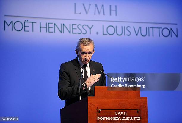 Bernard Arnault, chairman and chief executive officer of LVMH Moet Hennessy Louis Vuitton SA, right,speaks at a news conference at the Espace Louis...