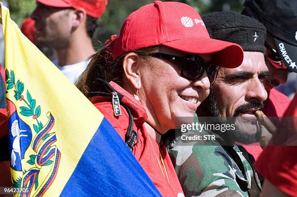 Supporters of Venezuelan President Hugo Chavez, one of them imitating the looks of revolutionary leader Argentine-born Ernesto "Che" Guevara ,...