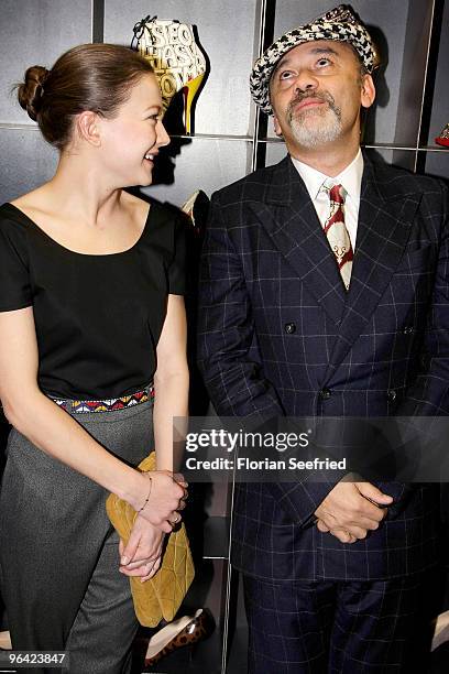 Actress Hannah Herzsprung and shoe Designer Christian Louboutin attend the 'Christian Louboutin' cocktail reception at The Corner Shop on February 4,...