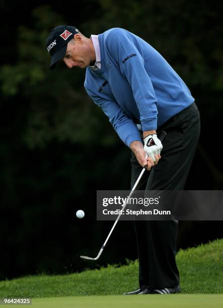 Jim Furyk chips onto the 12th green during the first round of the Northern Trust Open at Riveria Country Club on February 4, 2010 in Pacific...