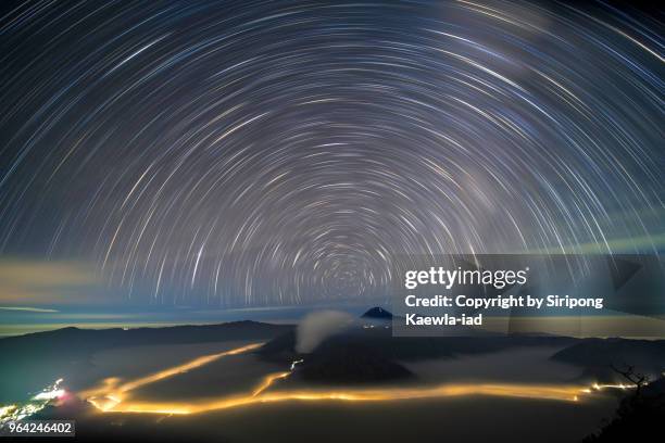 the star trails over the mt.semeru, mt.bromo and mt.batok, east java, indonesia. - mt semeru stock-fotos und bilder