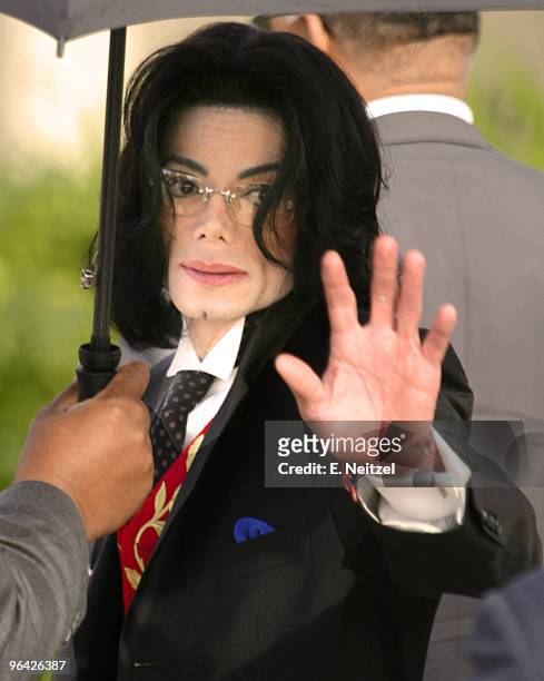 Pop superstar Michael Jackson gestures to his supporters as he arrives at the Santa Barbara Superior Court in Santa Maria, California at the start of...