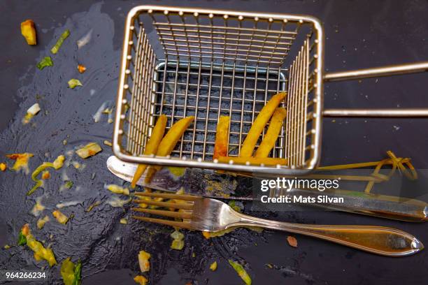 empty deep-fryer with french fries - fancy french fries stock pictures, royalty-free photos & images