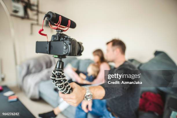 familly vlogging themselves on the sofa - youtuber stock pictures, royalty-free photos & images