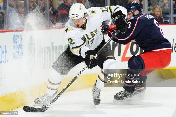 Jan Hejda of the Columbus Blue Jackets chases after Raymond Sawada of the Dallas Stars as he controls the puck in the corner during the first period...