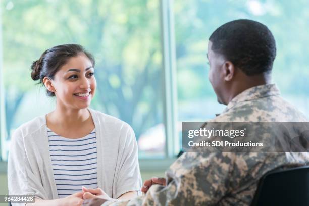 young woman talks with recruitment officer - army officer stock pictures, royalty-free photos & images