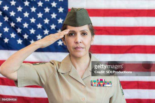 female soldier saluting the american flag - military salute stock pictures, royalty-free photos & images