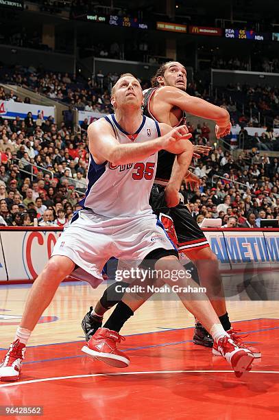 Chris Kaman of the Los Angeles Clippers rebounds against Joakim Noah of the Chicago Bulls during the game at Staples Center on January 20, 2010 in...