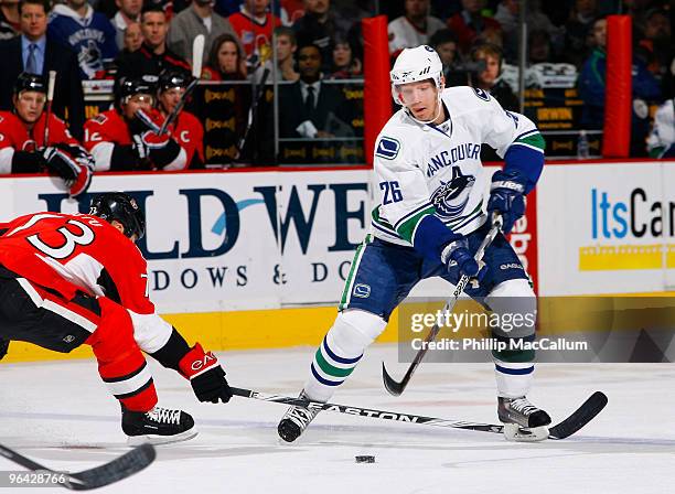 Mikael Samuelsson of the Vancouver Canucks dekes around Jarkko Ruutu of the Ottawa Senators with the puck at the blueline in a game at Scotiabank...