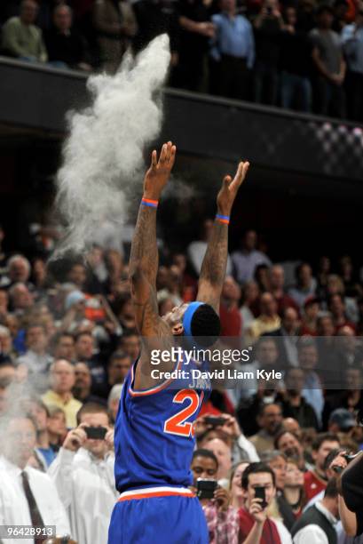 LeBron James of the Cleveland Cavaliers tosses talc powder high into the air prior to the opening tip-off against the Miami Heat on February 4, 2010...